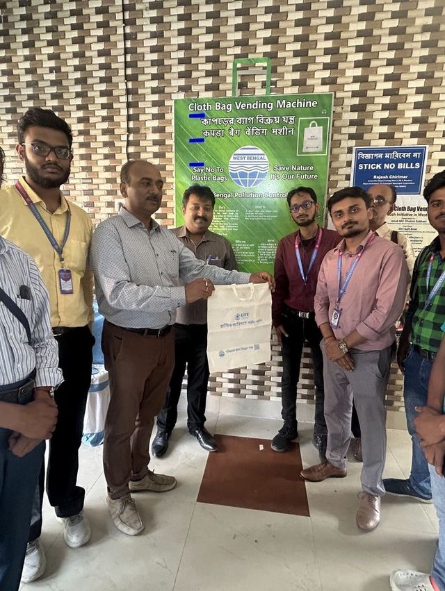 Handing over a cloth bag vending machine to a client team
